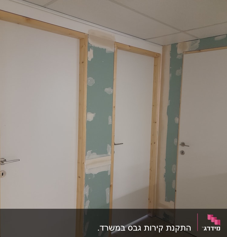 קירות גבס עם דלתות לבנות ומסגרות עץ